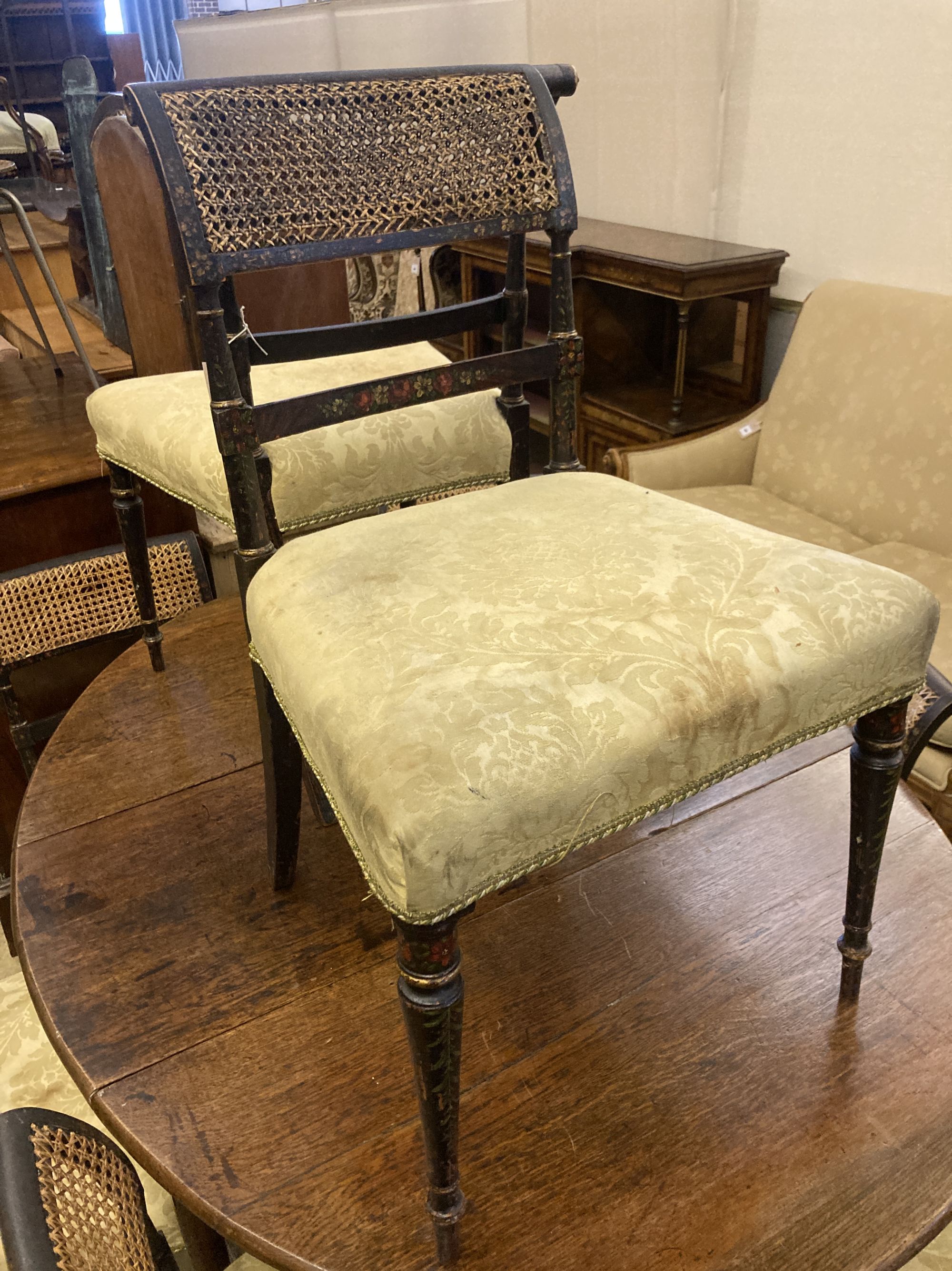 A set of eight Regency painted dining chairs with caned backs, width 50cm, depth 42cm, height 83cm